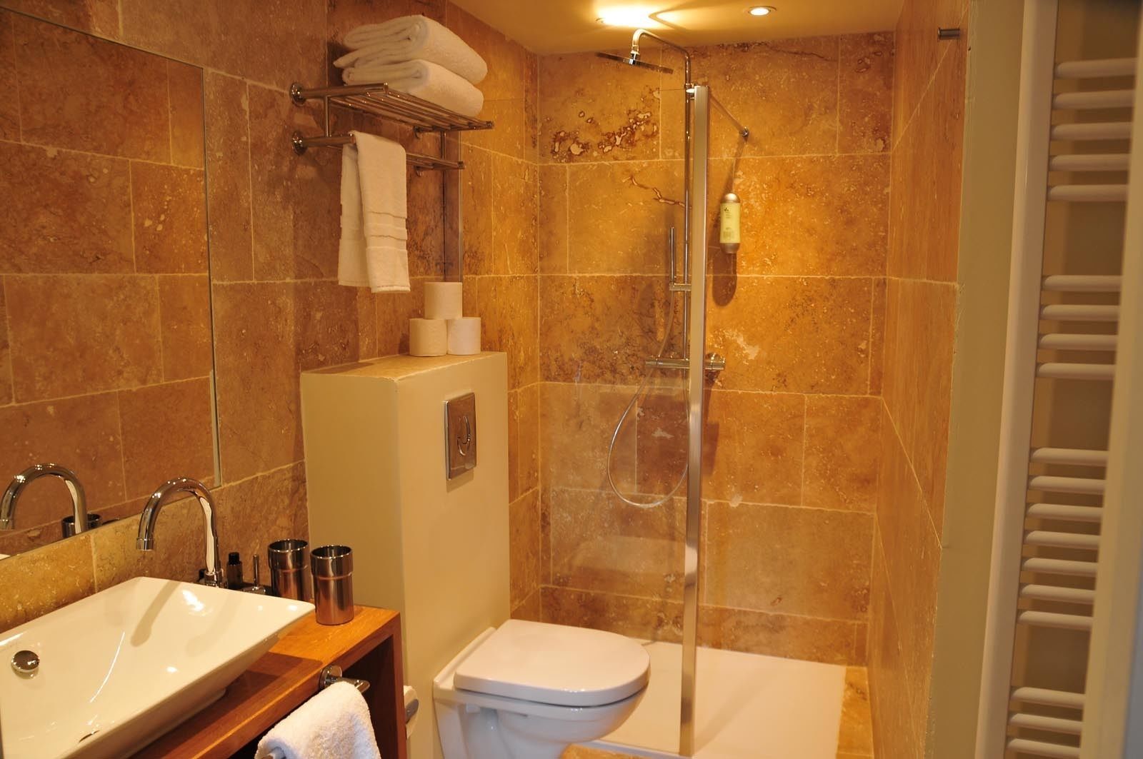 A bathroom with a sink, toilet, and shower.