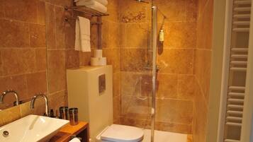 A bathroom with a sink, toilet, and shower.