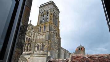 A historic church with a tall bell tower and a smaller adjacent structure.