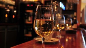 A bar setting with a glass of wine on the counter. - Hôtel & Restaurant SY La Terrasse (Vezelay)
