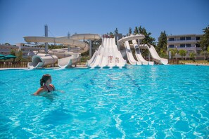 A swimming pool with a water slide structure.