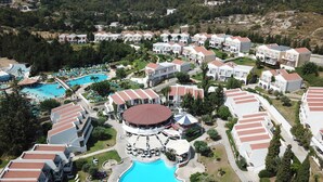 An aerial view of a resort with multiple buildings, a central swimming pool, and surrounding greenery. - Cyprotel Faliraki - All Inclusive (Rhodes)