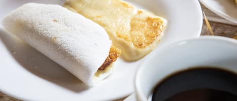 A plate with a pastry and a cup of coffee.