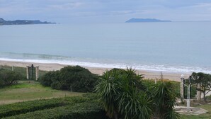 A coastal view with a beach, a gate, and greenery. - Akti Anastasia (Corfu)