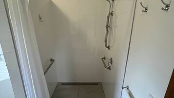 A bathroom with a shower, a toilet, and a sink.