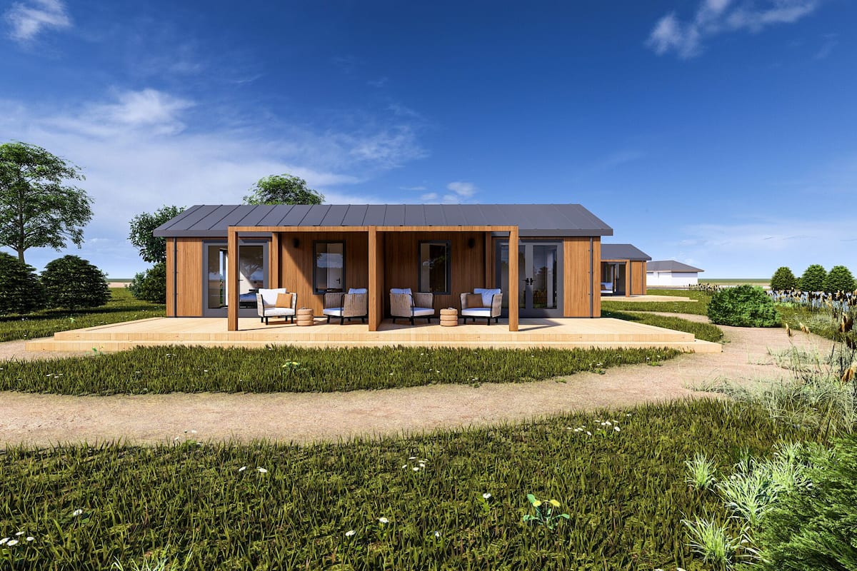 A modern house with a covered patio, outdoor seating, and a well-maintained garden.