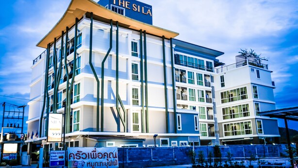 A modern hotel with multiple floors, large windows, and balconies. - The Sila Sriracha (Si Racha)