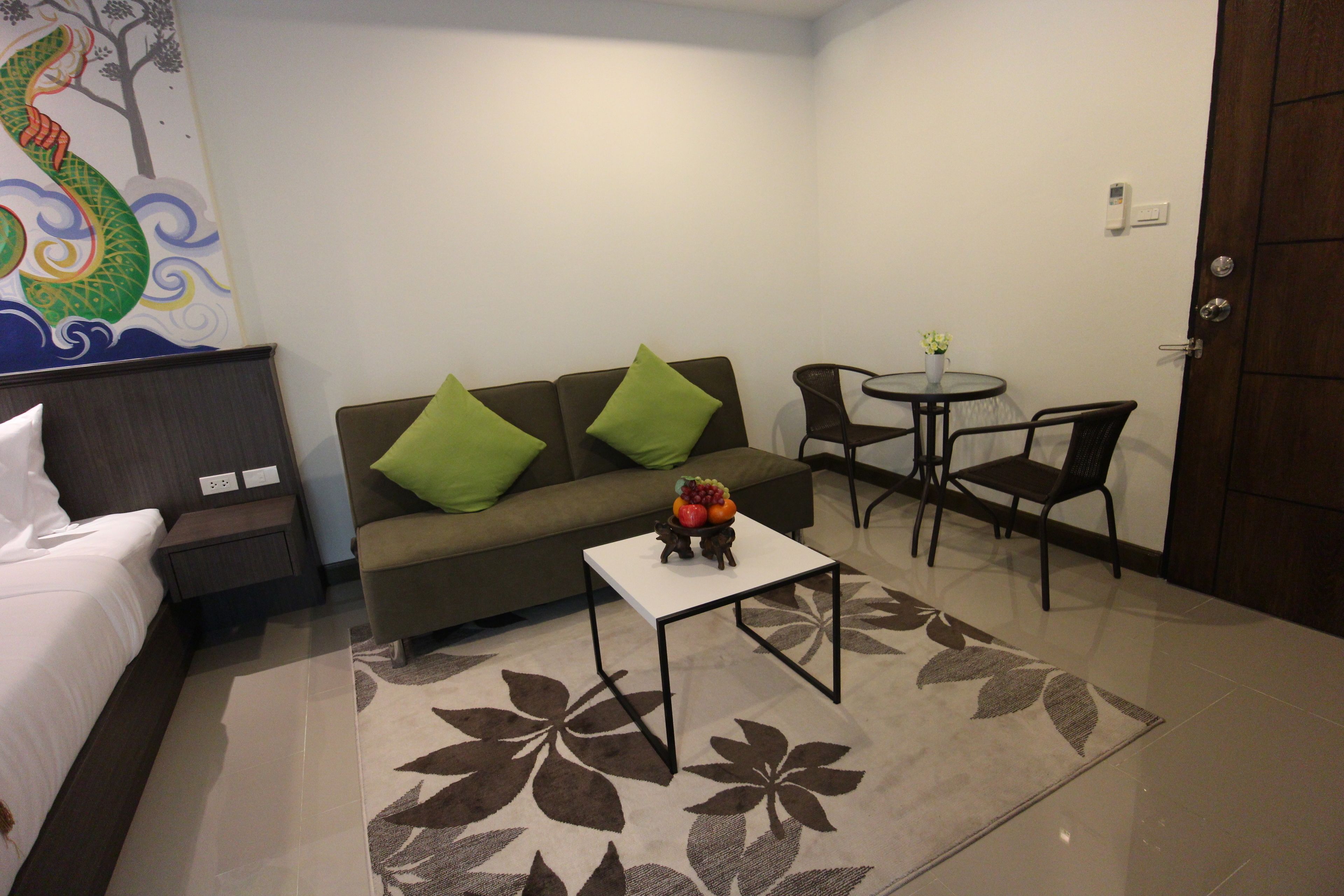 Junior Studio Suite, 1 King Bed, Garden View | Living area | Flat-screen TV