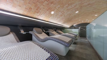 Relax in a serene space with a unique brick ceiling, massage chairs, and a patterned carpet.