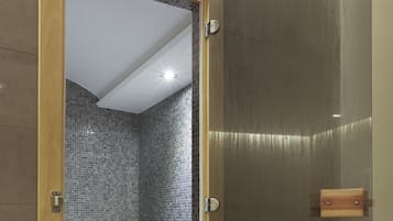 Bathroom features a glass shower enclosure with a mosaic tile design.