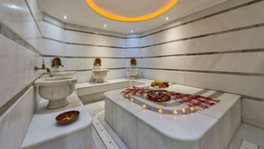 A modern bathroom with marble walls, a bathtub, and a sink. - Darkmen 2 Hotel  (Istanbul)