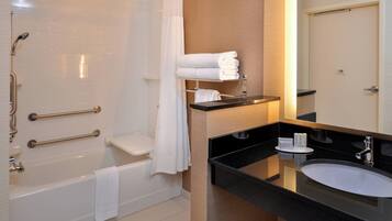 A modern bathroom with a bathtub, a sink, and a shower.
