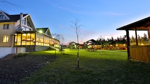 A residential area with a house, a covered outdoor seating area, and a well-maintained lawn. - Bon Hotel City & Resort (Silivri)