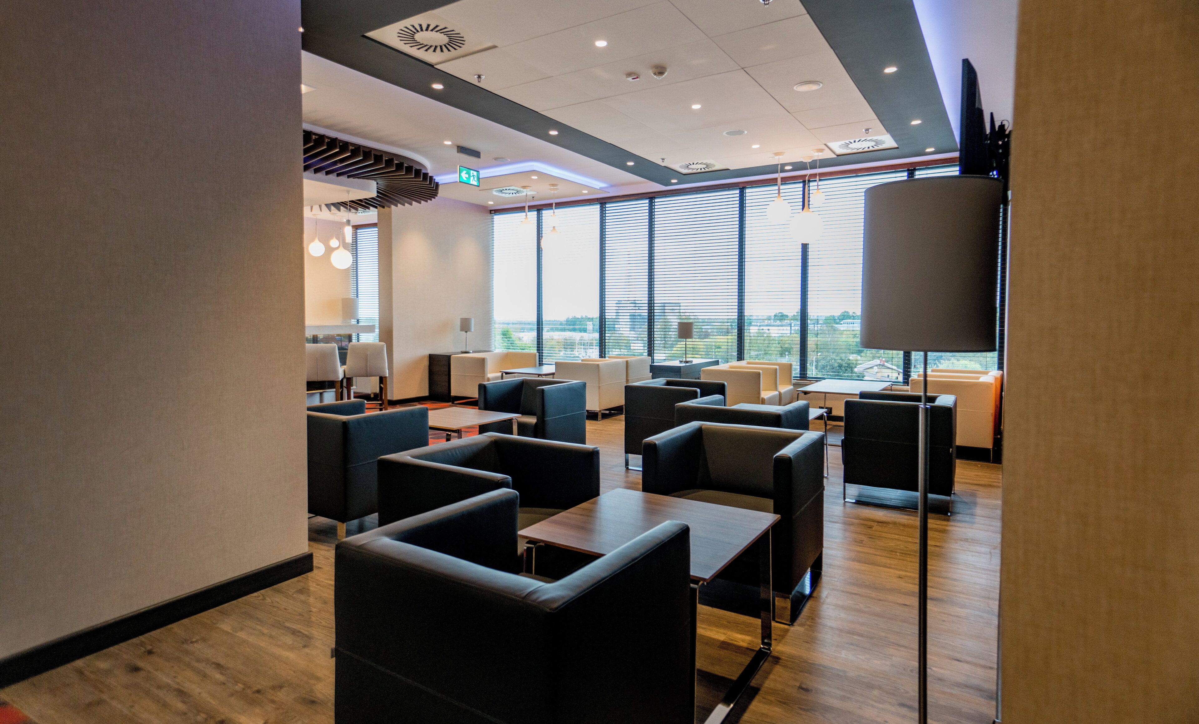 A modern interior with seating arrangements and large windows.