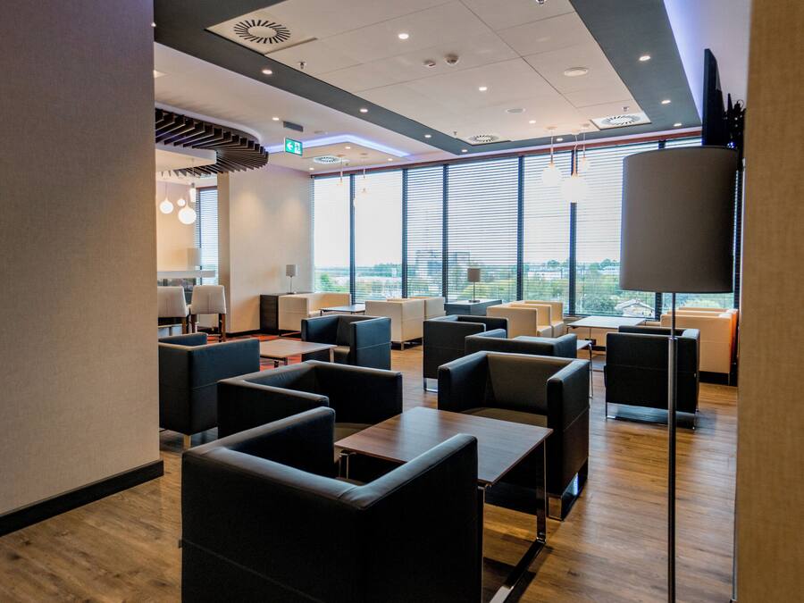 A modern interior with seating arrangements and large windows.