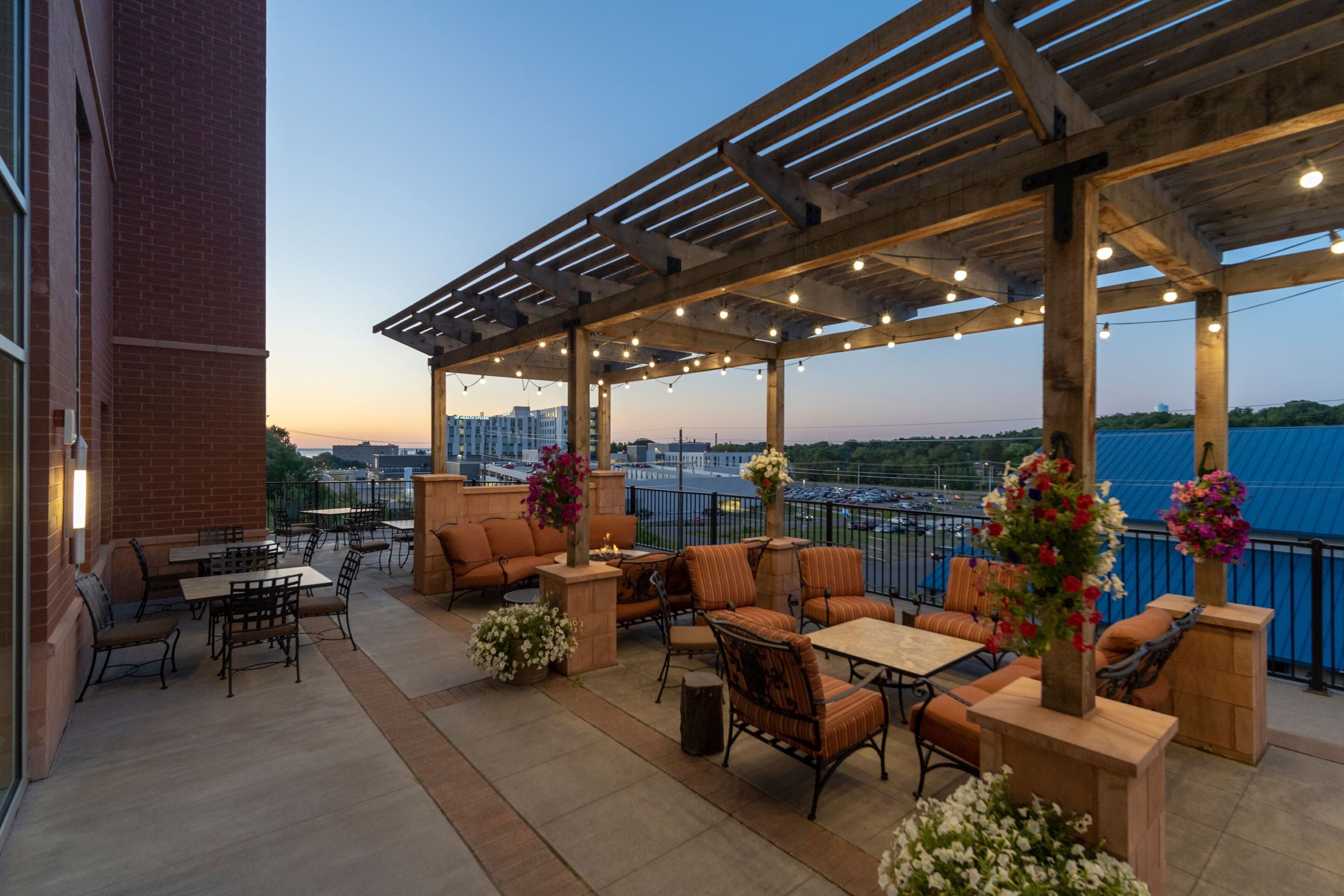 An outdoor patio area with seating arrangements and string lights.