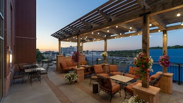 An outdoor patio area with seating arrangements and string lights.