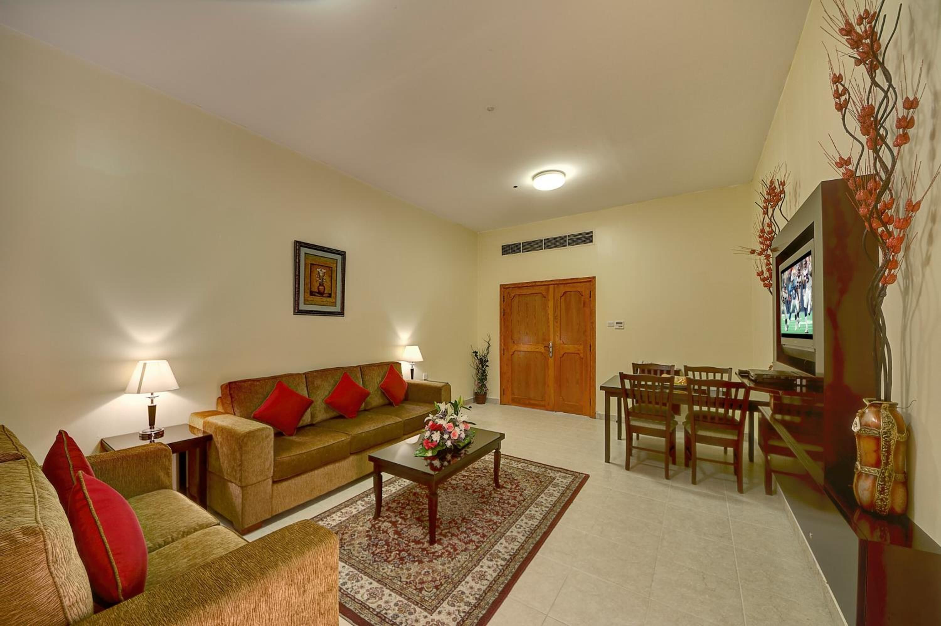A living room with a sofa, coffee table, and dining area.