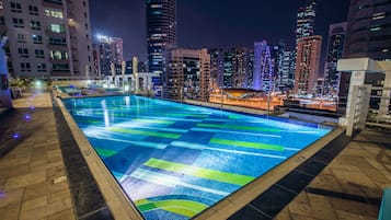 Una piscina al aire libre, tumbonas