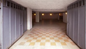 A corridor with checkered flooring and grey walls, leading to a door at the end. - Astoria Hotel Tbilisi (Tbilisi)
