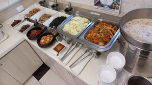A buffet with various dishes, including kimchi, vegetables, and a pot of soup. - Toyoko Inn Seoul Dongdaemun 1 (Seoul)