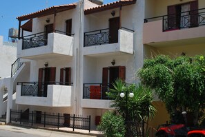 A multi-story building with balconies, a staircase, and a fence. - Koula Apartments (Hersonissos)
