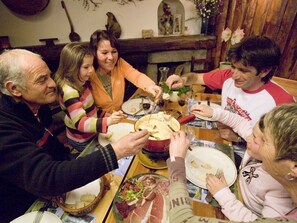 Gather around the table for a family-style meal in a warm and inviting space.
