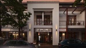 A building with a storefront named "Eike Hoff" and adjacent shops. - Eikehoff Apartment  (Stellenbosch)