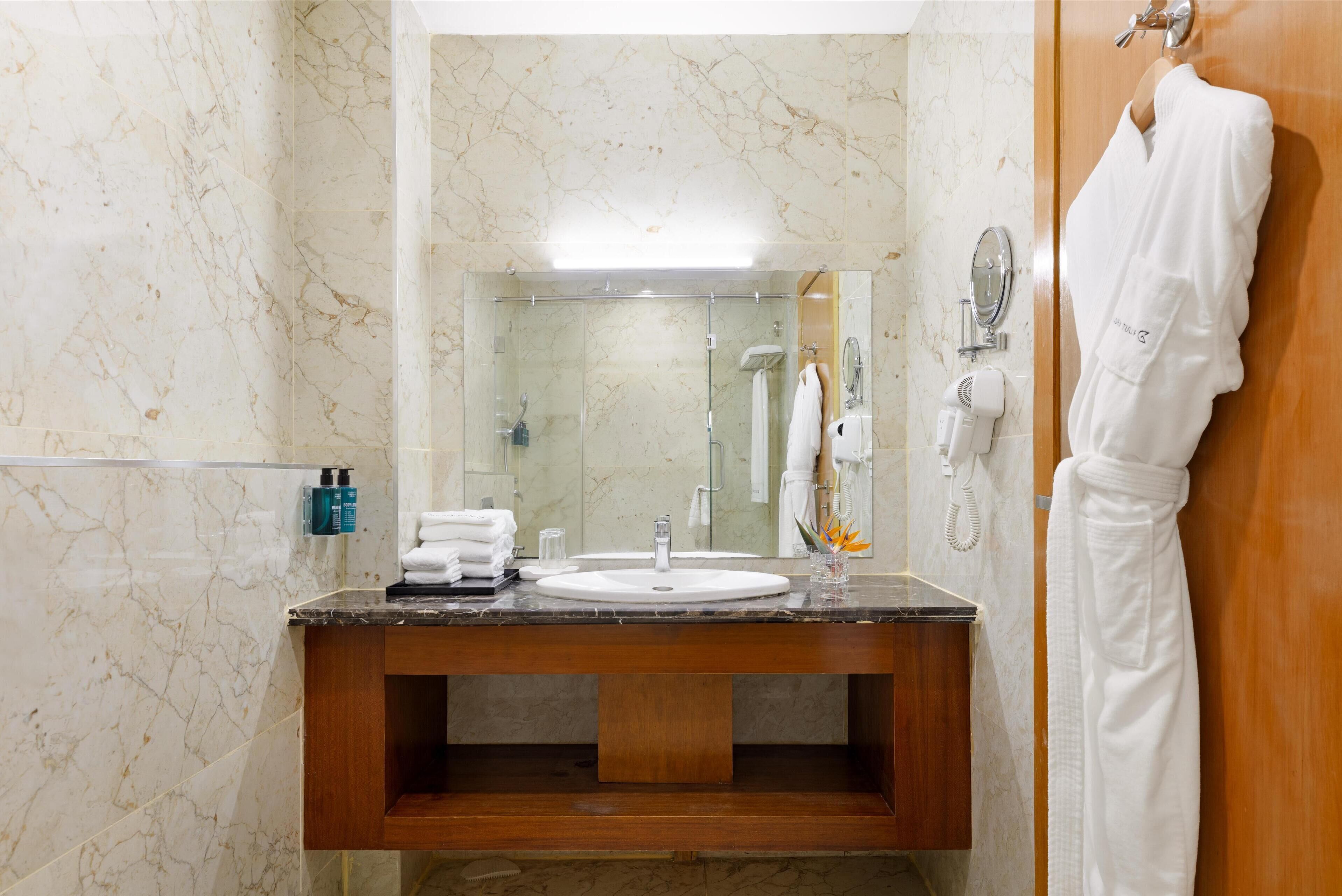 junior suite city view | bathroom | shower, rainfall showerhead, eco-friendly toiletries, hair dryer