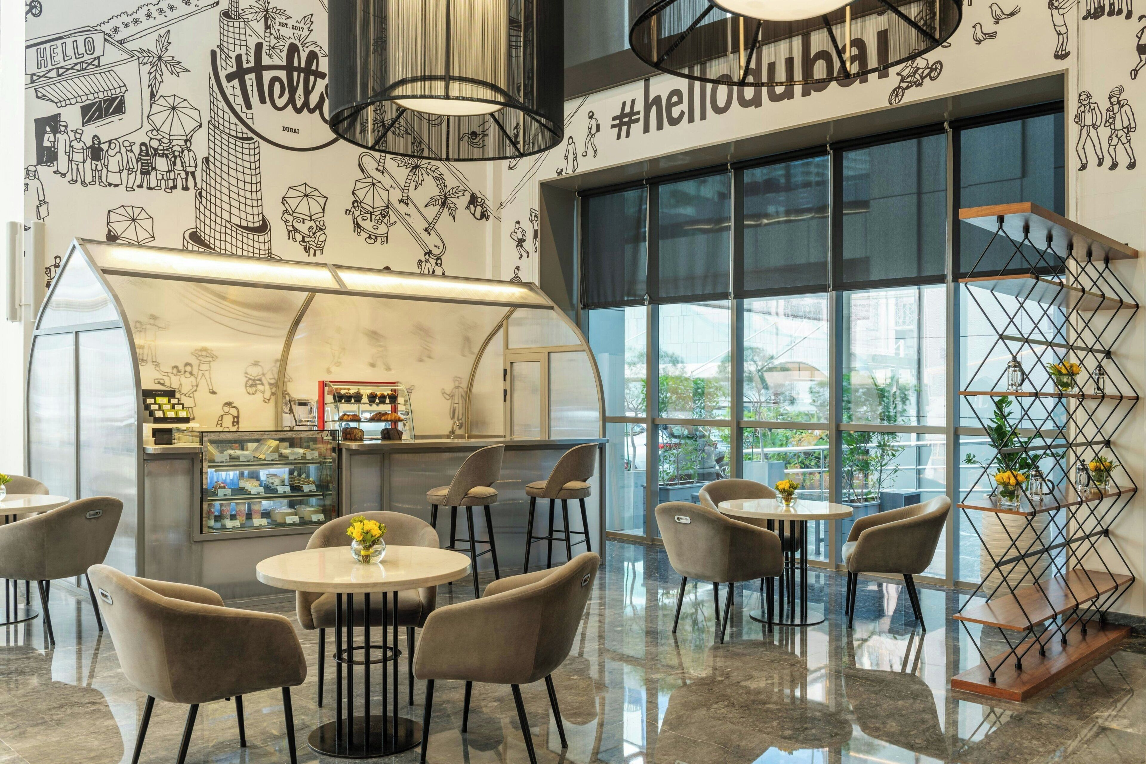 A modern interior with a bar area, seating, and large windows.