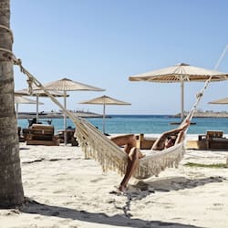 Playa privada, arena blanca, sillas reclinables de playa, sombrillas