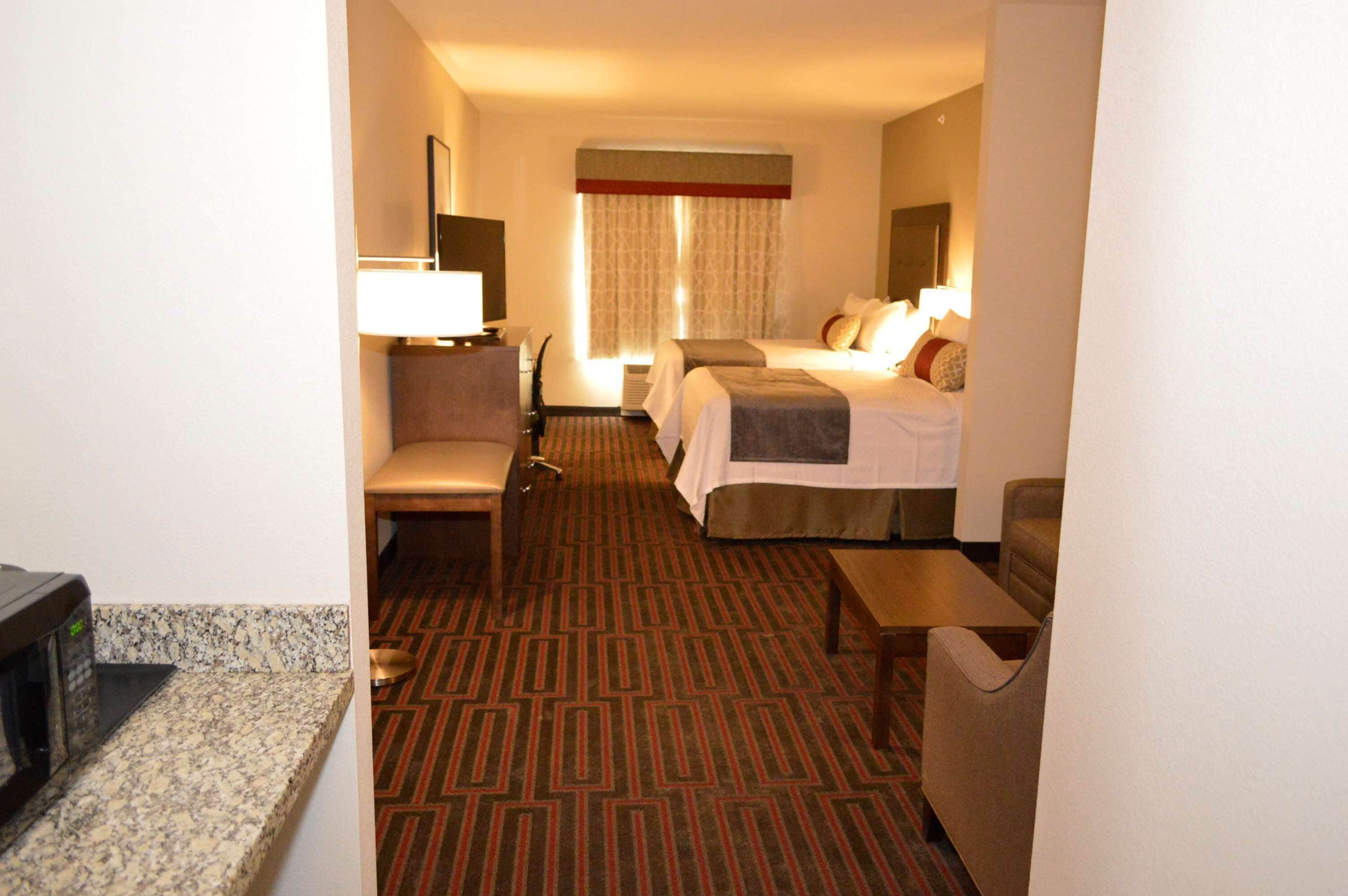 pillow-top beds, desk, laptop workspace, blackout curtains