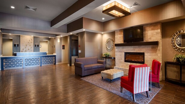 A spacious lobby with a reception desk, seating area, and a fireplace. - Best Western Plus Stevens County Inn (Hugoton)