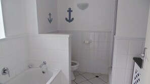 Separate bathtub and shower, towels