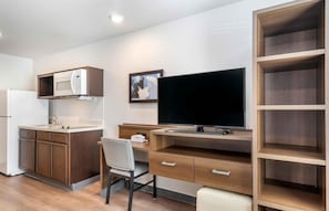 A compact kitchenette with a microwave, a sink, and a refrigerator. - Extended Stay America Select Suites - Clearwater (Clearwater)