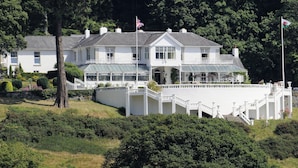 A large white building with multiple windows, a balcony, and a flag. - Plas Maenan Country House (Llanrwst)