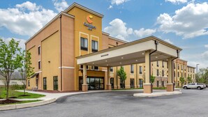 A Comfort Inn hotel with a covered entrance, brick facade, and a parking lot. - Comfort Inn PA Turnpike - 1-81 (Carlisle)