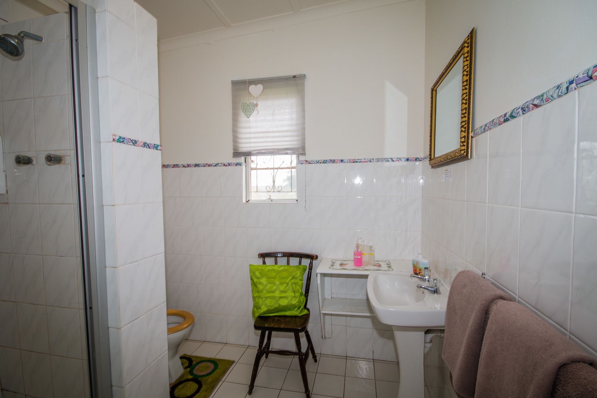 A bathroom with a shower, toilet, and sink.