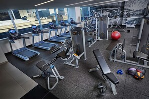 A gym with treadmills, weight machines, and exercise balls. - Hilton Cleveland Downtown (Cleveland)