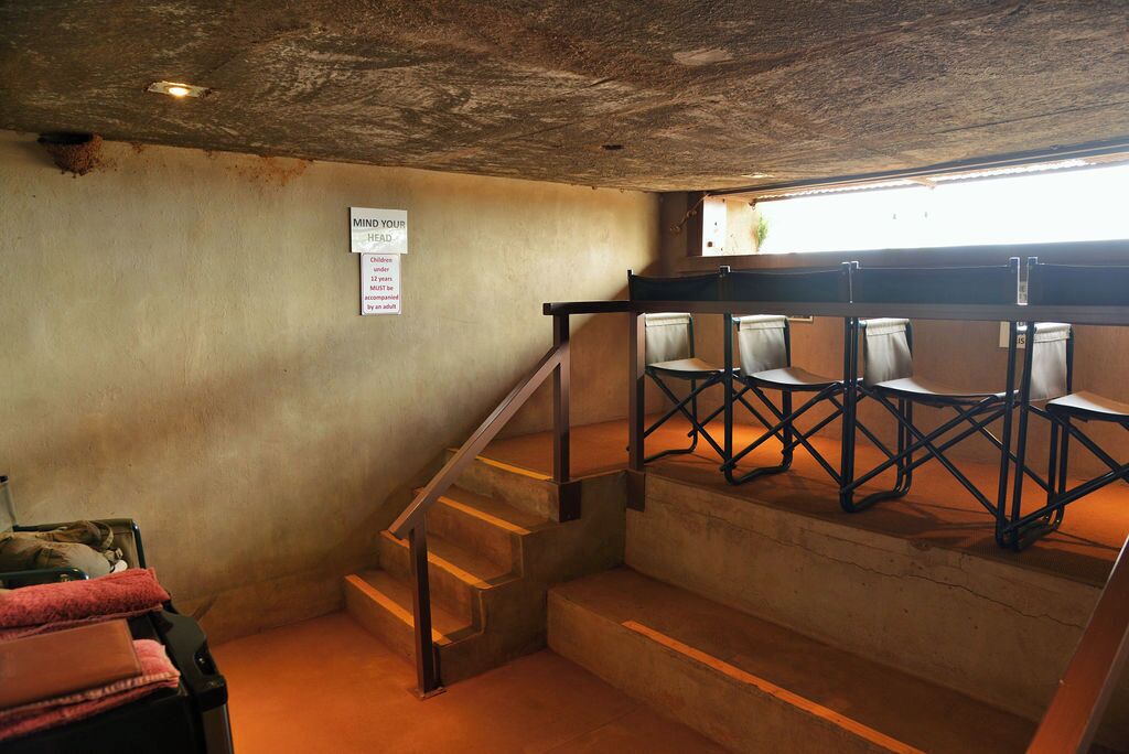 A staircase with a metal railing leading to a landing.