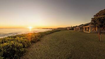 Guests can enjoy serene ocean views from the large windows of these single-story buildings.