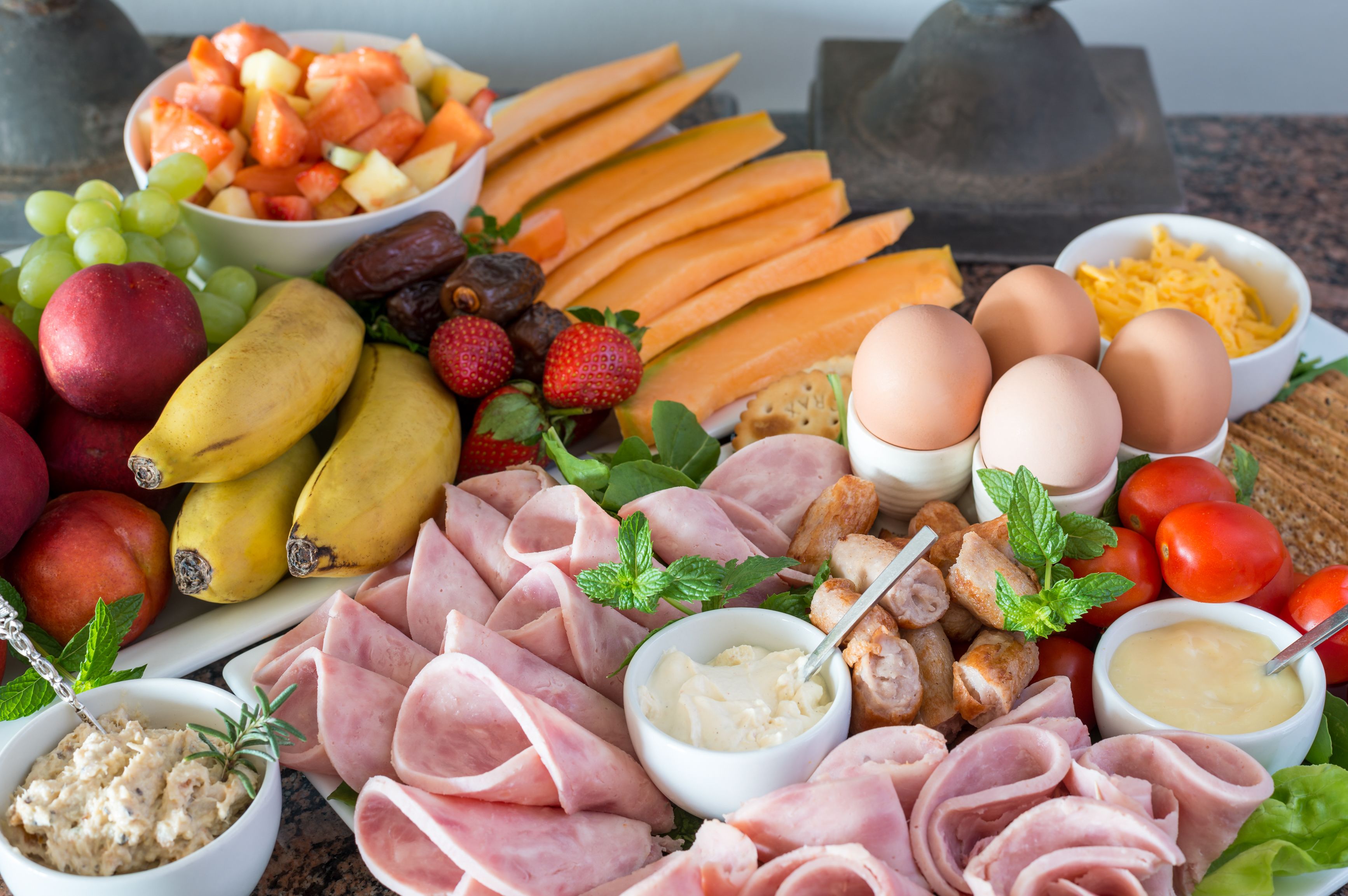 Eine Platte mit verschiedenen Fleisch-, Käse-, Obst- und Gemüsesorten.