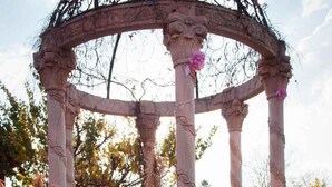 A gazebo with ornate columns and a circular roof, surrounded by tall ornamental grasses and flowers. - Acre of Africa Guest Venue (Boksburg)