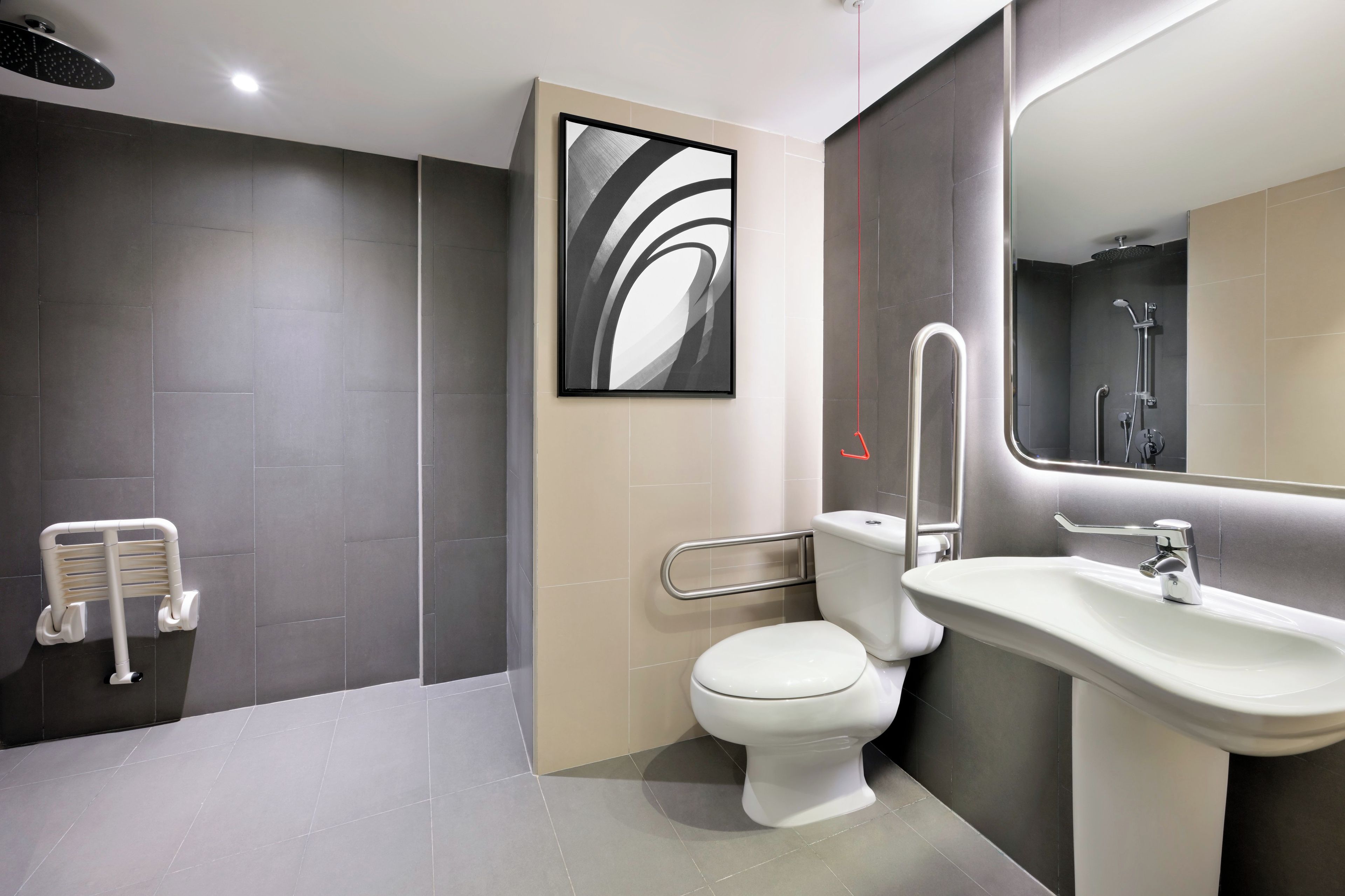 A modern bathroom with a toilet, bidet, and shower.