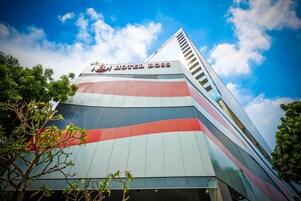 A modern hotel building with a prominent sign reading "HOTEL BOSS".