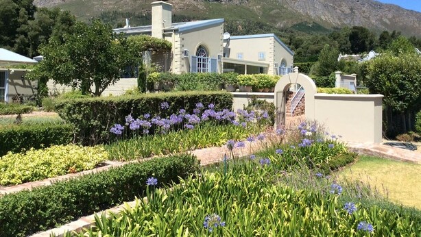 A building with a stone facade, a large arched entrance, and a mountain in the background.