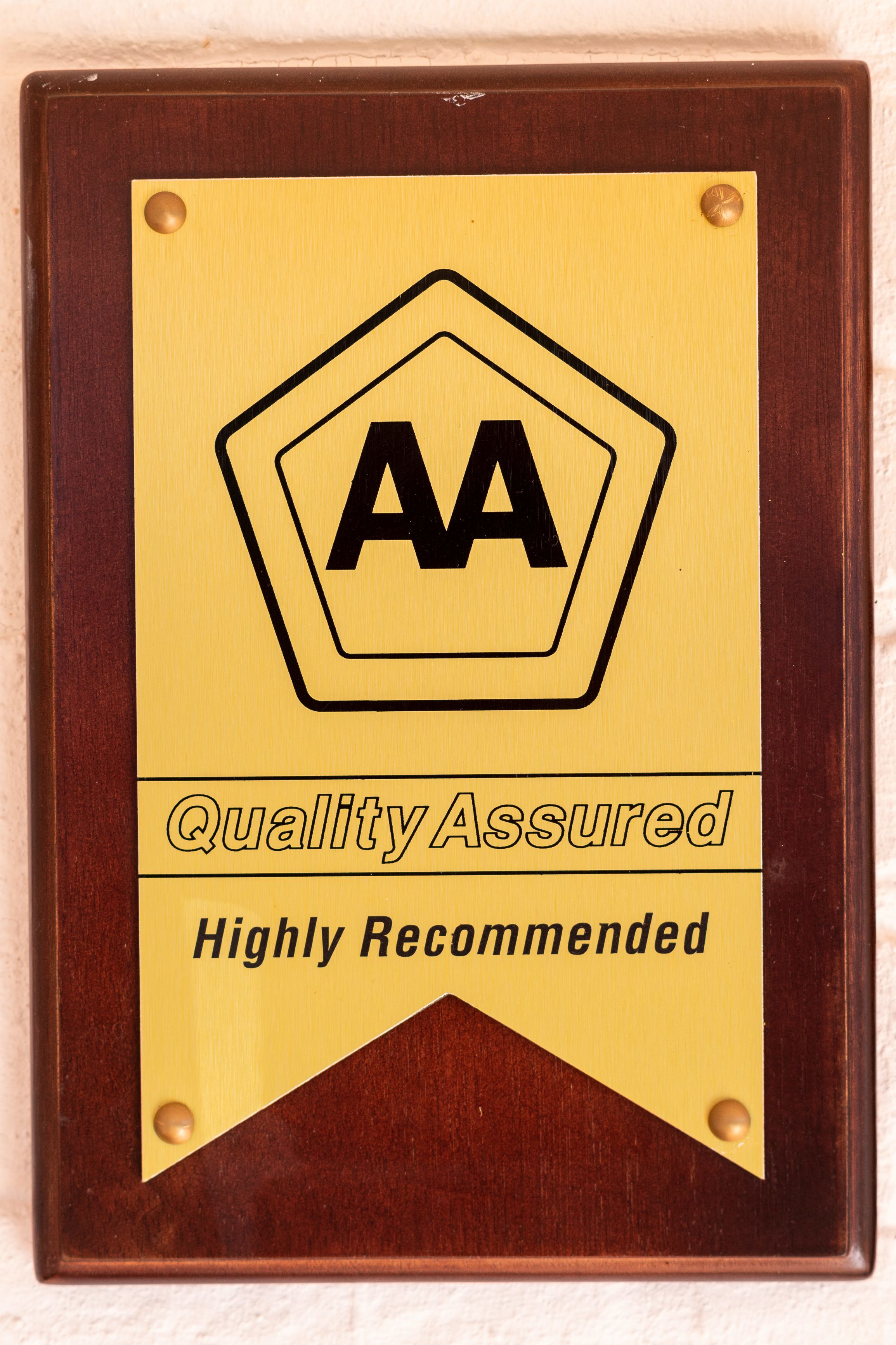 A plaque with the AA logo and the text "Quality Assured" and "Highly Recommended."