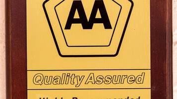 A plaque with the AA logo and the text "Quality Assured" and "Highly Recommended."