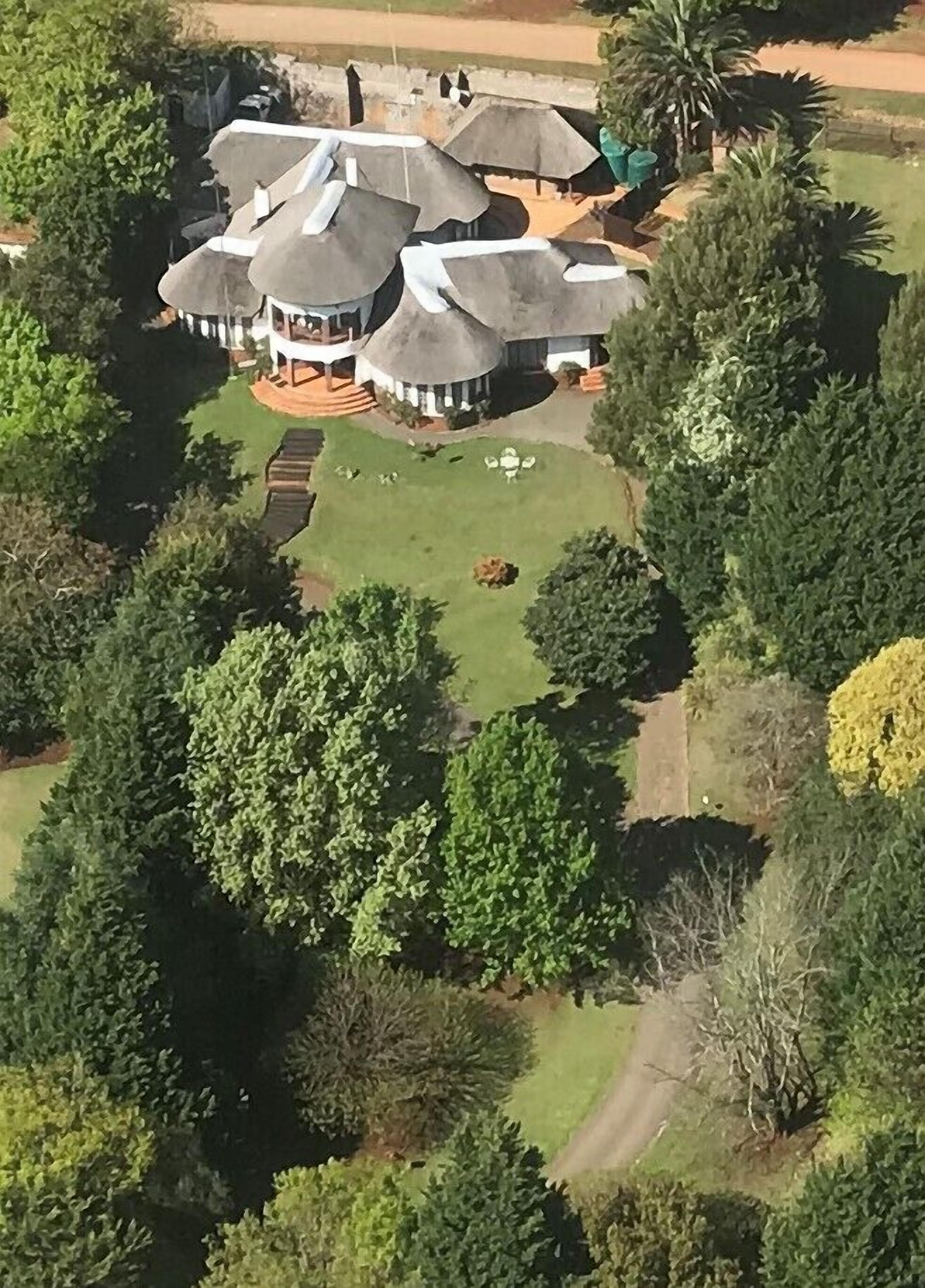 A large, open-plan house with multiple rooms and a central courtyard.