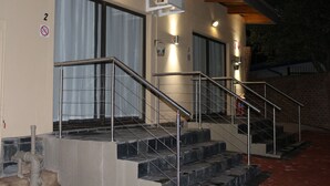A staircase with metal railings leading to a door with a window. There is a number '2' on the wall and a no-smoking sign. - 85 Ehmke (Mbombela)